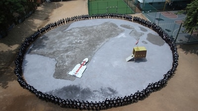 Chandrayaan 3 success: Children with faces painted stand around a replica of the moon at their school premises in Chennai. (AP) Chandrayaan 3 success: Children with faces painted stand around a replica of the moon at their school premises in Chennai. (AP)