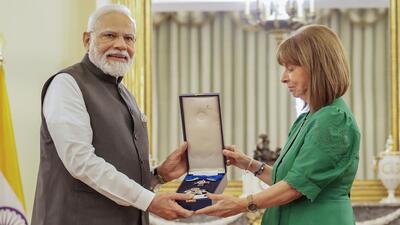 Prime Minister Narendra Modi being conferred with the Grand Cross of the Order of Honour by the President of Greece Katerina Sakellaropoulou in Athens on Friday (PTI/Via PIB) Prime Minister Narendra Modi being conferred with the Grand Cross of the Order of Honour by the President of Greece Katerina Sakellaropoulou in Athens on Friday (PTI/Via PIB)