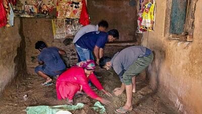 Residents engaged in clearing debris in a landslide affected village near Peepalkoti Bandh area of Uttarakhand. (PTI)