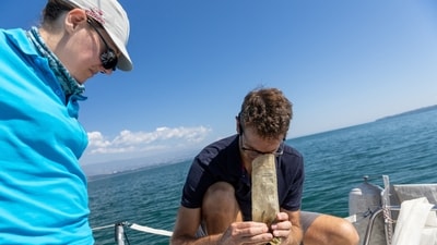 Pascal Hagmann, founder and director of NGO Oceaneye, and Laurianne Trimoulla, head of communication, look at the samples of weeds and plastic fragments that were collected in the water of Lake Leman in Founex, near Geneva, Switzerland August 21. (REUTERS)
