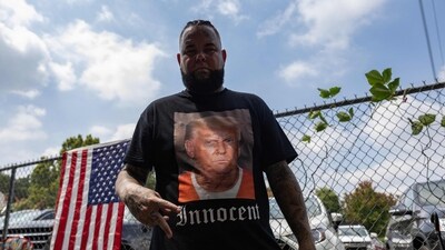 A supporter of former President Donald Trump wears a shirt proclaiming his innocence while waiting for him to arrive outside the Fulton County Jail on August 24, 2023, in Atlanta, Georgia. (Source: AFP) (AFP) A supporter of former President Donald Trump wears a shirt proclaiming his innocence while waiting for him to arrive outside the Fulton County Jail on August 24, 2023, in Atlanta, Georgia. (Source: AFP) (AFP)