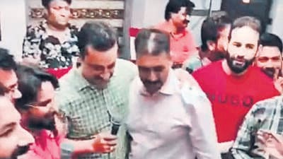 The two DSPs, Sanjeev Kumar (in check shirt) and Parvesh Chopra (white shirt), and gangster Kamal Kumar alias Bori (in red t-shirt) at the birthday party. (HT File) The two DSPs, Sanjeev Kumar (in check shirt) and Parvesh Chopra (white shirt), and gangster Kamal Kumar alias Bori (in red t-shirt) at the birthday party. (HT File)