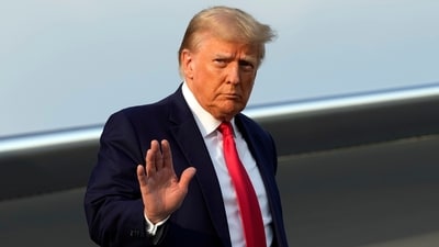 Former President Donald Trump steps off his plane as he arrives at Hartsfield-Jackson Atlanta International Airport on Thursday in Atlanta. (AP Photo) Former President Donald Trump steps off his plane as he arrives at Hartsfield-Jackson Atlanta International Airport on Thursday in Atlanta. (AP Photo)