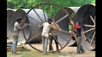 Works underway as part of a project sanctioned ahead of Mahakumbh in 2025, in Prayagraj on Friday. The wheel-like structure (in the photo) will be used in the making of pontoon or floating bridges to inter-link the mega tent city to come up on the banks of Sangam. (Anil Kumar Maurya/HT) Works underway as part of a project sanctioned ahead of Mahakumbh in 2025, in Prayagraj on Friday. The wheel-like structure (in the photo) will be used in the making of pontoon or floating bridges to inter-link the mega tent city to come up on the banks of Sangam. (Anil Kumar Maurya/HT)