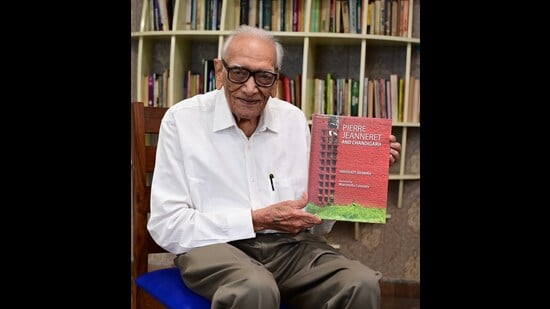 Author Shivdatt Sharma with his book about Pierre Jeanneret’s work at Chandigarh Press Club on Thursday. (Keshav Singh/HT)