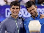 Carlos Alcaraz of Spain and Novak Djokovic of Serbia pose with their trophies after the final of the Western & Southern Open at Lindner Family Tennis Center Carlos Alcaraz of Spain and Novak Djokovic of Serbia pose with their trophies after the final of the Western & Southern Open at Lindner Family Tennis Center