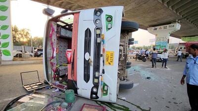 A bus carrying Maruti Suzuki employees fell on its side, injuring several passengers, after a speeding truck rammed it early Saturday morning near Vatika Chowk in Gurugram. (Parveen Kumar/HT Photo)