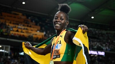Jamaica's Shericka Jackson celebrates with her National flag and gold medal after the women's 200m final during the World Athletics Championships (AFP)