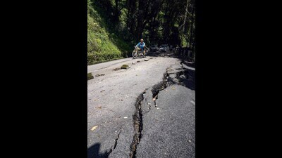 Cracks caused by heavy rain on a road in Shimla. (PTI) Cracks caused by heavy rain on a road in Shimla. (PTI)
