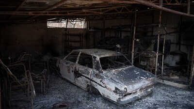 The view of a burned car after a wildfire in the Fyli suburb, northwest Athens, Greece, Friday, Aug. 25. (AP) The view of a burned car after a wildfire in the Fyli suburb, northwest Athens, Greece, Friday, Aug. 25. (AP)