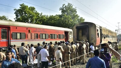 Security personnel and other officials at the spot after a fire broke out in a coach of a train at Madurai railway station, Saturday. (PTI) Security personnel and other officials at the spot after a fire broke out in a coach of a train at Madurai railway station, Saturday. (PTI)