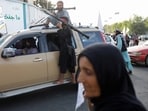 Taliban members celebrate on the second anniversary of the fall of Kabul.