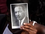 A person holds an image of the Rev. Martin Luther King Jr. as they listen to speakers during the 60th Anniversary of the March on Washington at the Lincoln Memorial in Washington, Saturday, Aug. 26, 2023. A person holds an image of the Rev. Martin Luther King Jr. as they listen to speakers during the 60th Anniversary of the March on Washington at the Lincoln Memorial in Washington, Saturday, Aug. 26, 2023.
