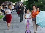 FILE - People walk in the Ryomyong street in Pyongyang, North Korea, Tuesday, Aug. 8, 2023. North Korea said Sunday, Aug. 27, it will allow its citizens staying abroad to return home in line with easing pandemic situations worldwide, as the country slowly eases its draconian pandemic restrictions. (AP Photo/Cha Song Ho, File)