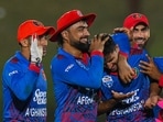 Afghanistan's Fazalhaq Farooqi (C) celebrates with teammates after the dismissal of Pakistan's captain Babar Azam