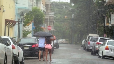 People walk in the rain brought by Tropical Storm Franklin in Santo Domingo, Dominican Republic, early Wednesday, Aug. 23, 2023. (AP Photo/Ricardo Hernandez) (AP) People walk in the rain brought by Tropical Storm Franklin in Santo Domingo, Dominican Republic, early Wednesday, Aug. 23, 2023. (AP Photo/Ricardo Hernandez) (AP)