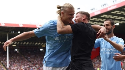 Erling Haaland celebrates scoring the opening goal with a Manchester City fan (AFP) Erling Haaland celebrates scoring the opening goal with a Manchester City fan (AFP)