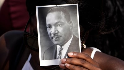A person holds an image of the Rev. Martin Luther King Jr. as they listen to speakers during the 60th Anniversary of the March on Washington at the Lincoln Memorial in Washington, Saturday, Aug. 26, 2023. (AP)