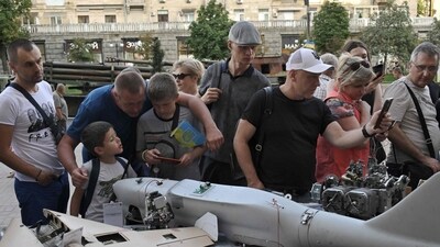 People look at remains of downed Russian drones (UAV) displayed by the Ukrainian army in Kiev's central Khreshchatyk street on August 22, 2023, ahead of Ukraine's Independence Day, amid the Russian invasion of Ukraine. (Photo by Genya SAVILOV / AFP) (AFP)