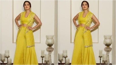 Her yellow outfit is from the clothing brand LOKA By Veerali Raveshia and consists of a V-neck crop top, matching flared trousers and a half-sleeved jacket adorned with intricate mirror work. (Instagram/@nushrrattbharuccha)
