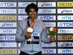 Gold medallist India's Neeraj Chopra celebrates on the podium with his medal after winning the final
