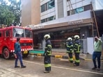 Firefighters outside the Galaxy Hotel after a fire broke out, at Santacruz in Mumbai.