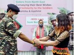 A girl ties Rakhi on a Jawan's wrist.