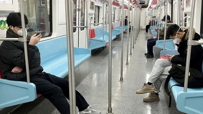 Commuters wearing face masks ride a subway train. (Reuters) Commuters wearing face masks ride a subway train. (Reuters)