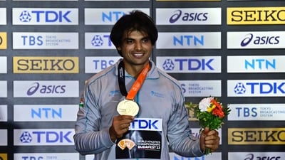 Gold medallist India's Neeraj Chopra celebrates on the podium with his medal after winning the final (REUTERS)