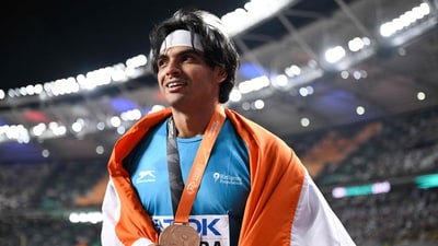 Gold medalist, India's Neeraj Chopra celebrates with his National flag and medal after the men's javelin throw final during the World Athletics Championships at the National Athletics Centre in Budapest (AFP) Gold medalist, India's Neeraj Chopra celebrates with his National flag and medal after the men's javelin throw final during the World Athletics Championships at the National Athletics Centre in Budapest (AFP)