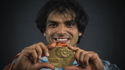 Neeraj shows off his world championships gold medal. (AFP) Neeraj shows off his world championships gold medal. (AFP)