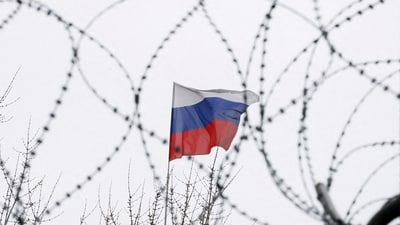 The Russian flag is seen through barbed wire as it flies on the roof of the Russian embassy in Kiev, Ukraine. (Representational image) (REUTERS)