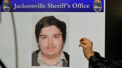 A photograph of shooter Ryan Christopher Palmeter is shown on a video monitor during Sheriff T.K. Waters' press conference at the Jacksonville Sheriff's Office headquarters building in Jacksonville, Fla., Sunday, Aug, 27, 2023. (Bob Self/The Florida Times-Union via AP) (AP)