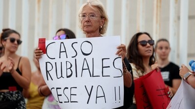 People hold banners as they protest against President of the Royal Spanish Football Federation Luis Rubiales (REUTERS)