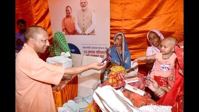 U.P. chief minister Yogi Adityanath offers sweet to a toddler at a flood relief camp in Kasganj district on Monday. (HT photo) U.P. chief minister Yogi Adityanath offers sweet to a toddler at a flood relief camp in Kasganj district on Monday. (HT photo)