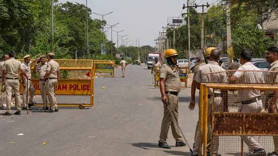 Sohna: Police personnel at a check post ahead of a rally of Hindu organisations to be taken out in Nuh, weeks after violence in the region, in Sohna. (PTI Photo) Sohna: Police personnel at a check post ahead of a rally of Hindu organisations to be taken out in Nuh, weeks after violence in the region, in Sohna. (PTI Photo)