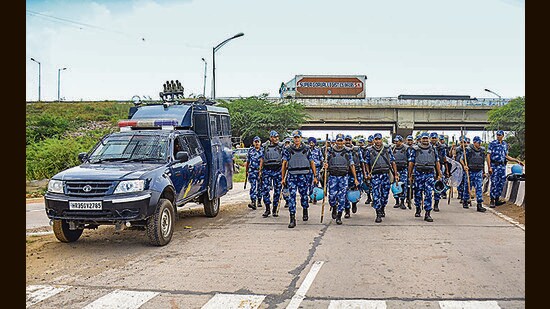 RAF personnel deployed at Gurugram- Nuh border in Nuh district on Monday. Heavy security arrangements have been put in place in Nuh in the view of the call for a 'Shobha Yatra' by Hindu organisations. In Jind, the police have detained Bajrang Dal leader Harish Ramkali when he was all set to leave his house to take part in shobha yatra in Nuh. (PTI)