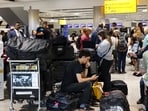 UK air traffic control glitch: Travellers wait near the British Airways check-in area at Heathrow Airport.