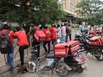 Gig workers wait in line to collect their delivery order outside a mall in Mumbai, India, August 10, 2023. REUTERS/Francis Mascarenhas