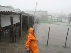 Idalia In Florida Updates: A woman walks on a flooded street as Storm Idalia makes landfall in Cuba.