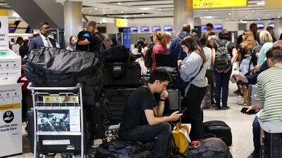 UK air traffic control glitch: Travellers wait near the British Airways check-in area at Heathrow Airport. (Reuters)