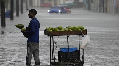 Idalia In Florida Updates: An avocado vender works in a street flooded by rain brought by Hurricane Idalia in Havana, Cuba. (AP) Idalia In Florida Updates: An avocado vender works in a street flooded by rain brought by Hurricane Idalia in Havana, Cuba. (AP)