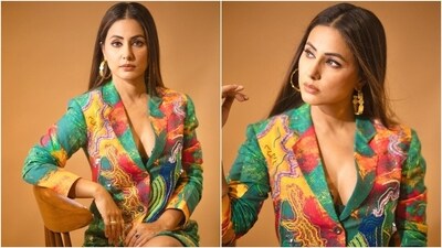 Hina layered the blazer dress over a dark green bralette featuring intricate floral lace embroidery and a plunging neckline highlighting her decolletage. (Instagram) Hina layered the blazer dress over a dark green bralette featuring intricate floral lace embroidery and a plunging neckline highlighting her decolletage. (Instagram)