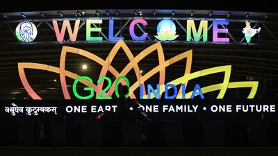 A man rides past an illuminated hoarding with the G20 logo displayed along a street in New Delhi. (AFP) A man rides past an illuminated hoarding with the G20 logo displayed along a street in New Delhi. (AFP)