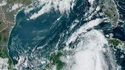 This image obtained from the National Oceanic and Atmospheric Administration (NOAA), shows tropical Storm Idalia (bottom right) approaching Cuba on August 28, 2023. Tropical Storm Idalia strengthened as it neared Cuba and the abnormally hot waters of the Gulf of Mexico on Monday, with forecasters predicting it could become a major hurricane before roaring ashore in Florida this week. (AFP) This image obtained from the National Oceanic and Atmospheric Administration (NOAA), shows tropical Storm Idalia (bottom right) approaching Cuba on August 28, 2023. Tropical Storm Idalia strengthened as it neared Cuba and the abnormally hot waters of the Gulf of Mexico on Monday, with forecasters predicting it could become a major hurricane before roaring ashore in Florida this week. (AFP)
