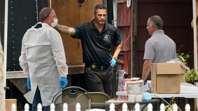 Authorities work outside as they search the home of suspect Rex Heuermann, Tuesday, July 18, 2023, in Massapequa Park, N.Y (AP Photo/John Minchillo) (AP) Authorities work outside as they search the home of suspect Rex Heuermann, Tuesday, July 18, 2023, in Massapequa Park, N.Y (AP Photo/John Minchillo) (AP)