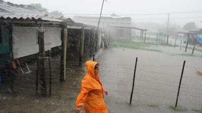 Idalia In Florida Updates: A woman walks on a flooded street as Storm Idalia makes landfall in Cuba. (Reuters)