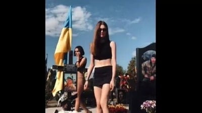 The screengrab of a purported video of Ukrainian girls dancing on soldiers' graves. (Reddit ) The screengrab of a purported video of Ukrainian girls dancing on soldiers' graves. (Reddit )
