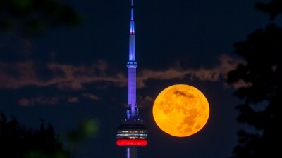 The August Super Blue Moon sets behind the CN tower in Toronto. (AP) The August Super Blue Moon sets behind the CN tower in Toronto. (AP)