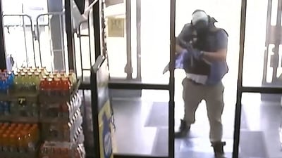 Ryan Christopher Palmeter, 21, is shown in a still image from surveillance video holding a rifle at a Dollar Store after being identified by Sheriff T.K. Waters as the white man who killed three Black people before shooting himself August 26, 2023 in what local law enforcement described as a racially motivated crime in Jacksonville, Florida, U.S. (via REUTERS)